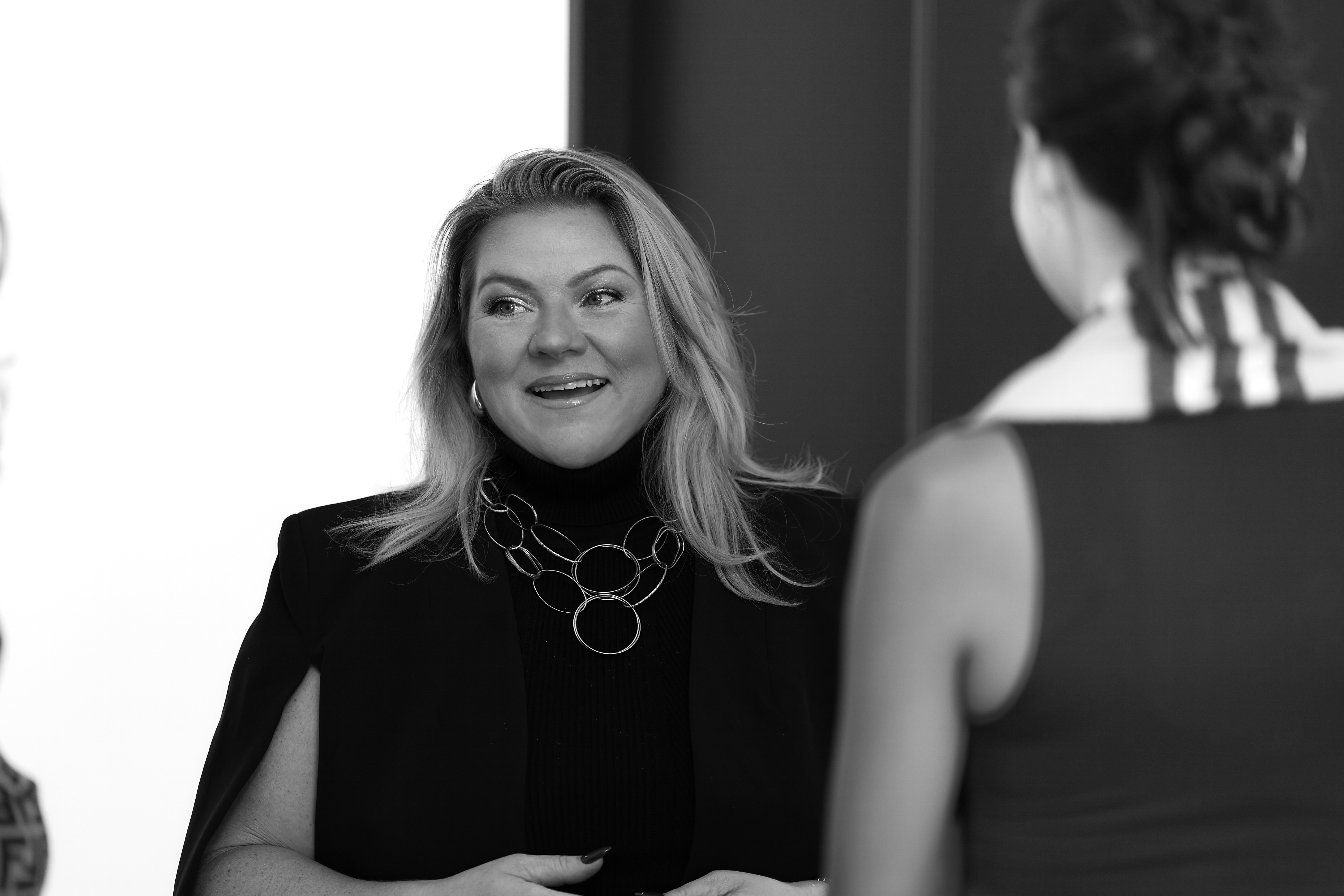 Christine Graf mid-conversation, animated and engaged