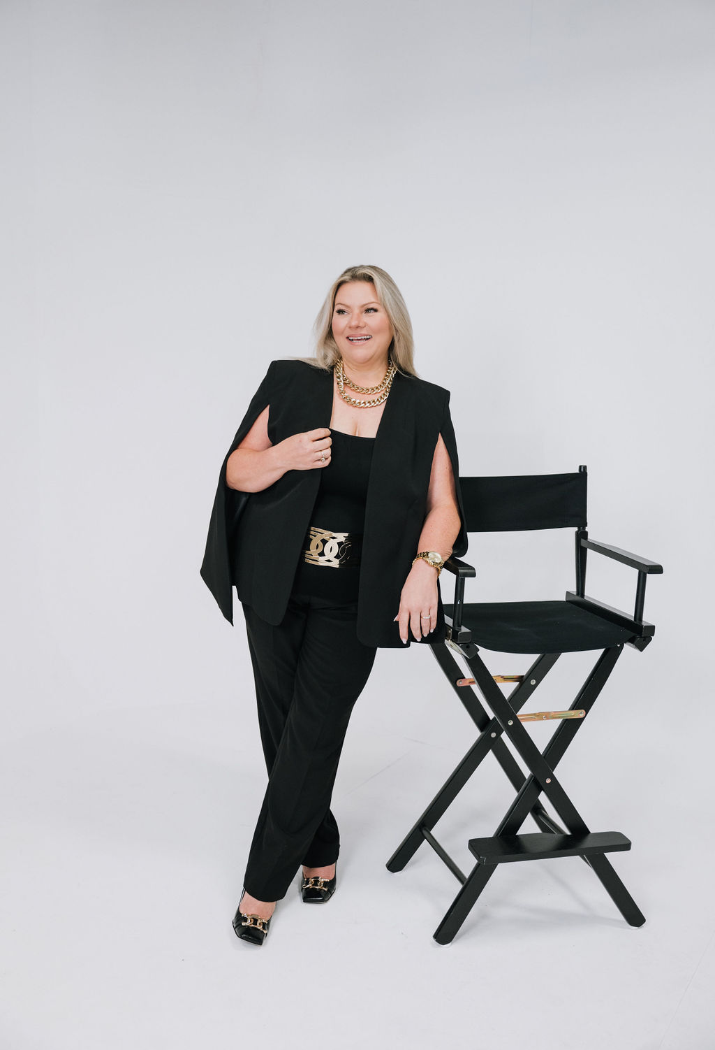 Christine Graf in a studio, leaning on a director's chair